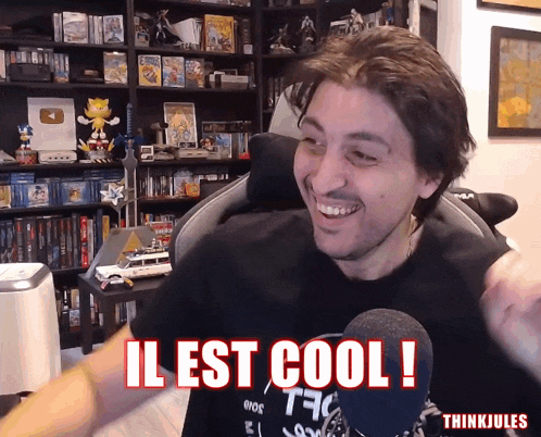 a man sitting in front of a microphone with the words il est cool in red letters