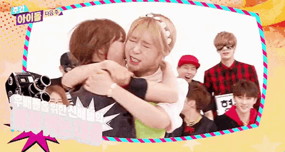 a group of people are hugging each other in front of a sign that says ' i love you '