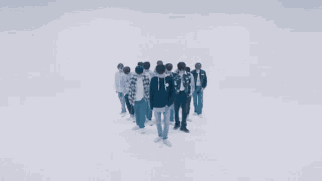 a group of young men are dancing in a dark room in a dark room .
