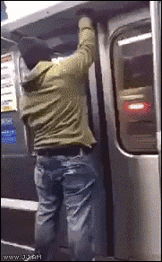 a man in a green jacket is getting off a train