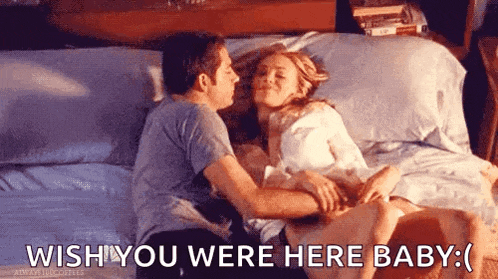 a man and a woman are kissing on a bed .