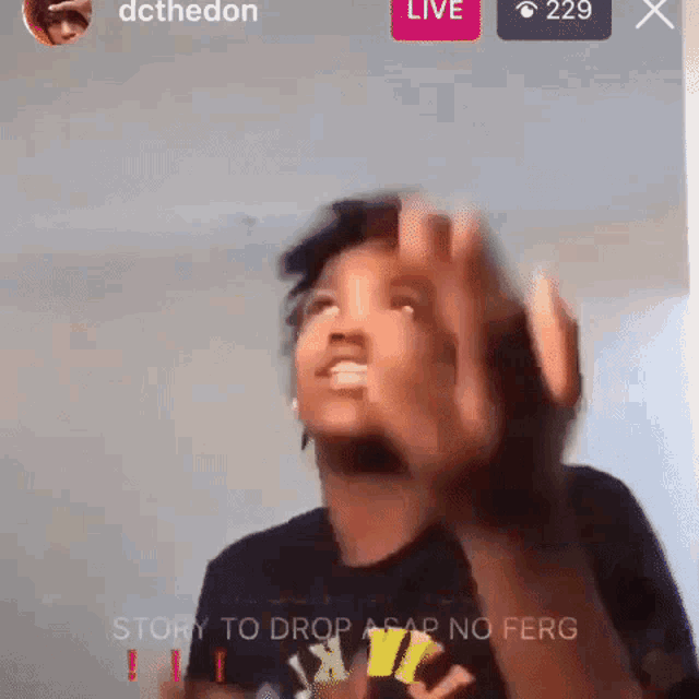 a person is waving their hands in front of a screen that says live 229 x