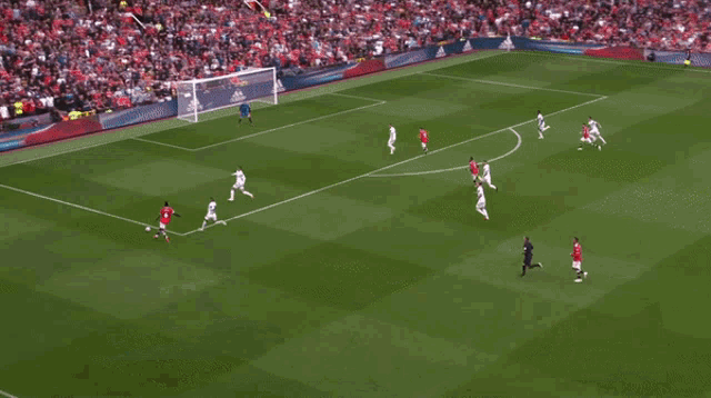 a soccer player in a red and white jersey is celebrating a goal .