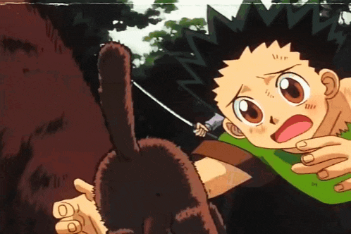 a boy in a green shirt is holding a sword in his right hand
