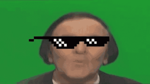 a man is wearing a pair of pixelated sunglasses on a green screen .