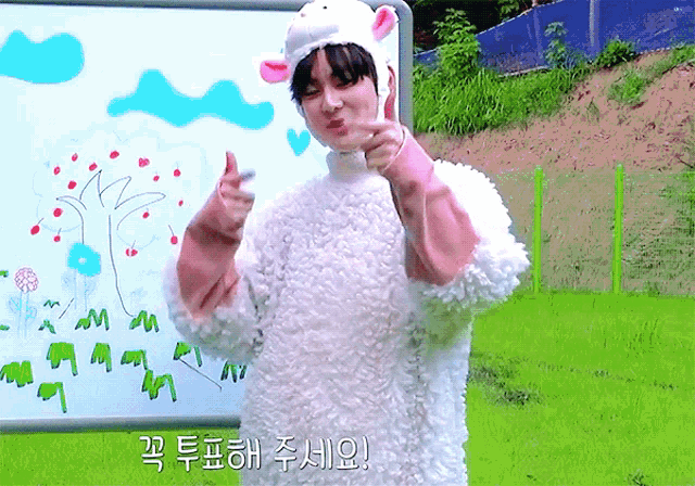 a boy wearing a sheep costume giving a thumbs up