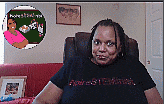 a woman is sitting in a chair wearing a black t-shirt that says apples & tomatoes