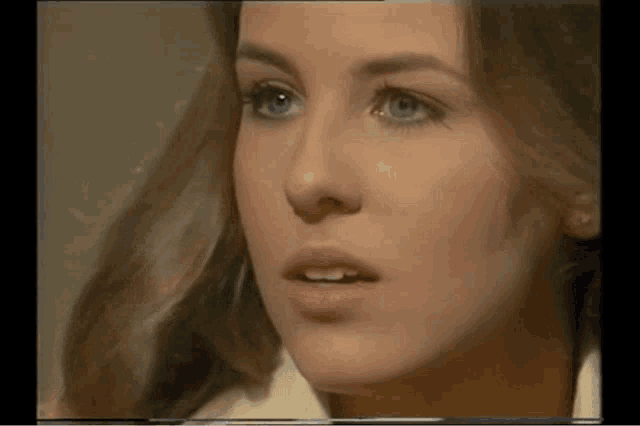 a close up of a woman 's face shows her blue eyes