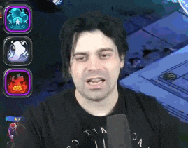 a man wearing a black t-shirt with the word tia on it is talking into a microphone .