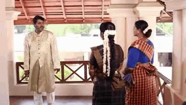 a bride and groom are standing next to each other in a room .