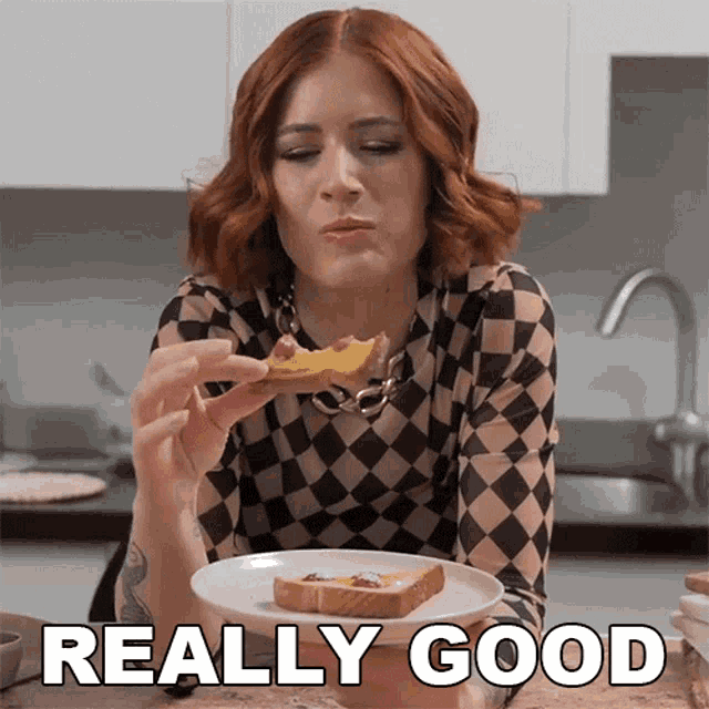 a woman in a checkered shirt is eating a piece of toast with the words really good behind her