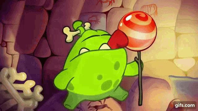 a green cartoon character is holding a red and white lollipop .
