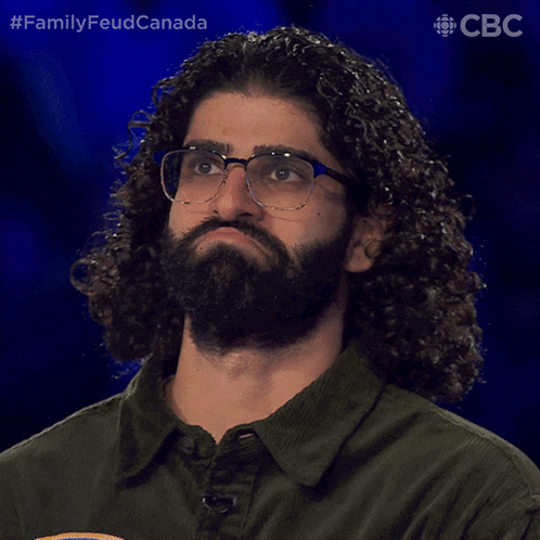 a man with glasses and curly hair says yeah