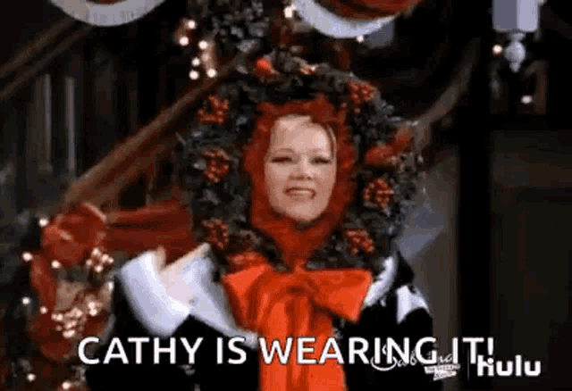 a woman is wearing a wreath on her head and says cathy is wearing it .