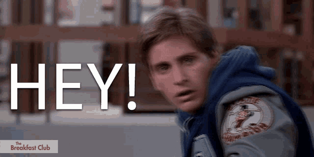 a man in a varsity jacket says hey in white letters
