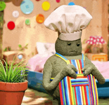 a stuffed turtle wearing a chef hat and apron