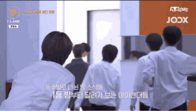 a group of people standing in front of a mnet logo