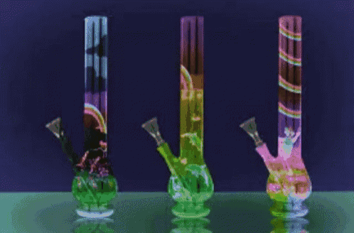 three colorful bongs are sitting on a table