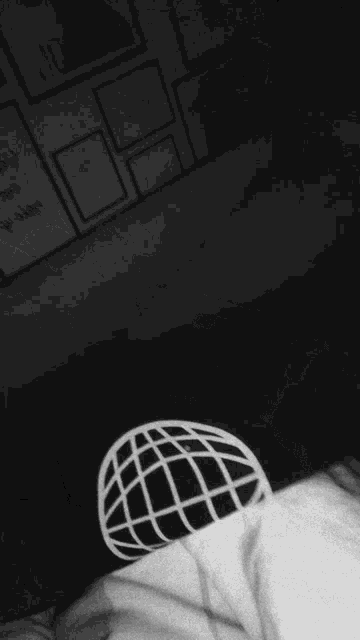 a blurry black and white photo of a person in a white shirt