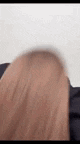 a close up of a woman 's hair against a white wall .