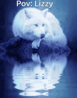 a white wolf laying on a rock in the water