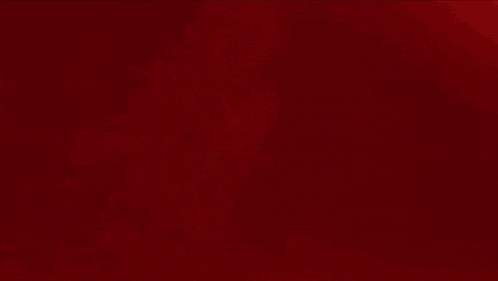 a person is standing in the dark with a red light behind them
