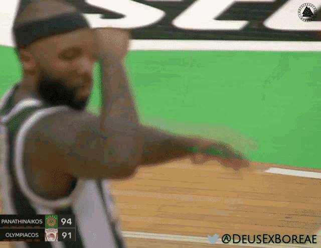 a basketball player wearing a green and white jersey with the number 94 on it