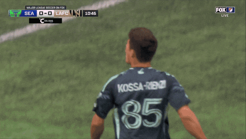 a blurry picture of a soccer player wearing a jersey with the number 36 on it
