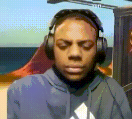a man wearing headphones and a hoodie looks at the camera