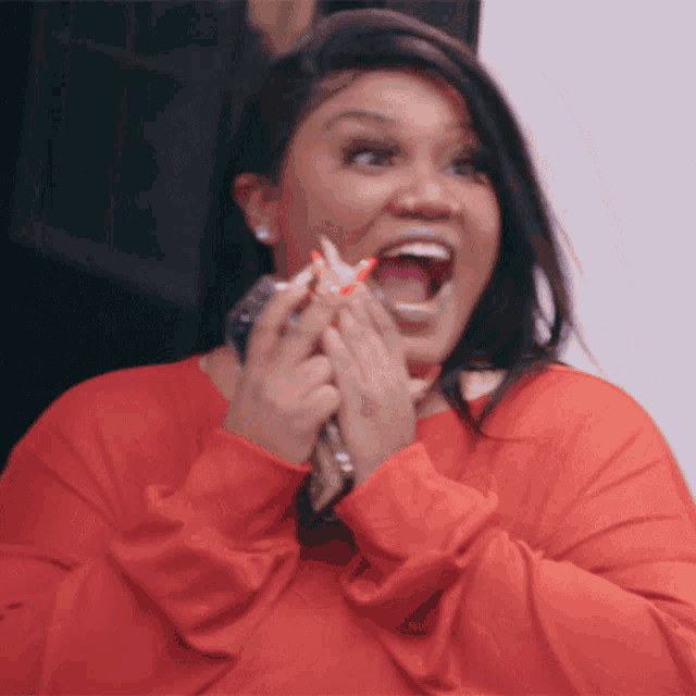 a woman in a red shirt with her mouth open