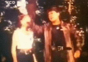 a blurry picture of a man and a woman with the letters mcd on the bottom left