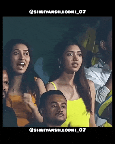 a group of people sitting in a stadium with the number 07 on the bottom right
