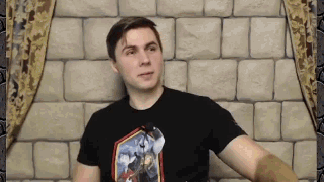 a man wearing a black shirt with a knight on it
