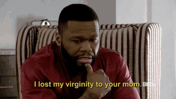 a man sitting in a chair with the words i lost my virginity to your mom