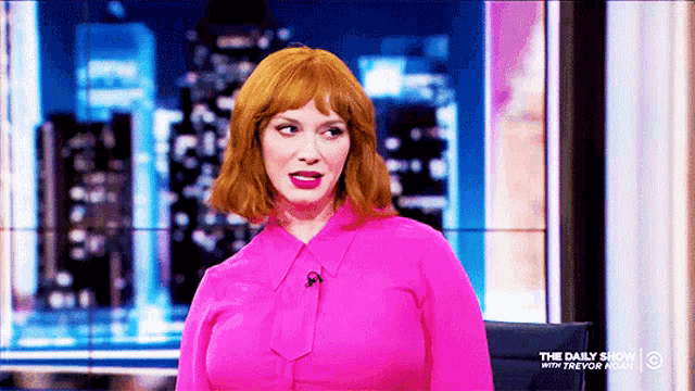 a woman in a pink shirt is on a show called the daily show