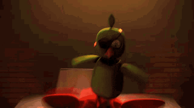 a red stuffed animal with sharp teeth is standing next to a green stuffed animal