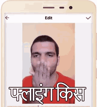 a phone with a picture of a man covering his nose with his hand and the word edit on the bottom