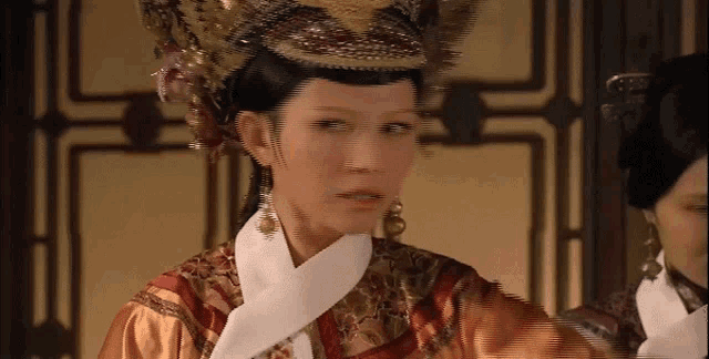 a woman with a crown on her head looks at something