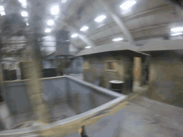 a blurry picture of a building with a barrel in the middle of it
