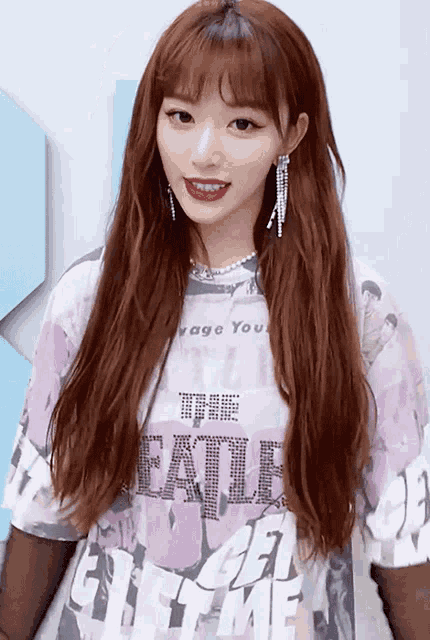 a girl wearing a purple shirt that says the beatles on it