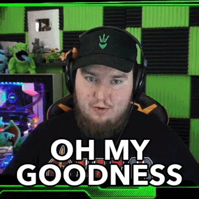 a man with a beard is wearing headphones and a hat and says oh my goodness