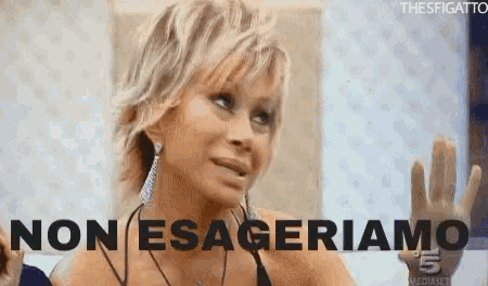 a woman with blonde hair and earrings says " non esageriamo "