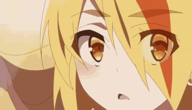 a close up of a girl 's face with yellow hair and brown eyes