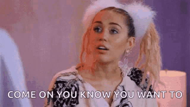 a woman wearing a furry headband is talking to someone .