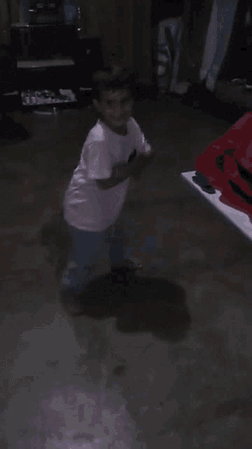 a little girl in a pink shirt is dancing
