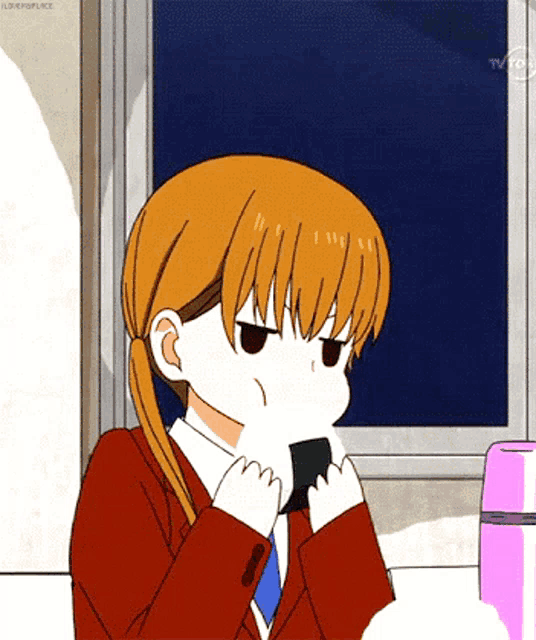 a girl in a school uniform is eating a piece of sushi
