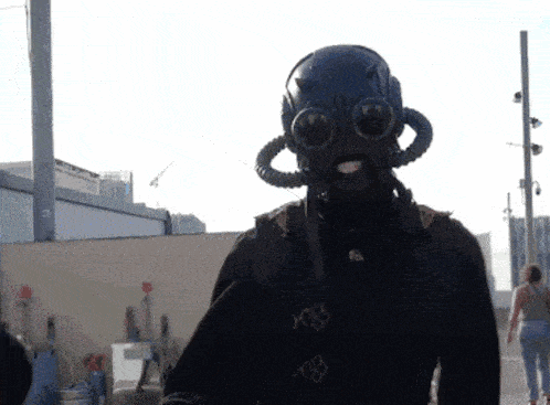 a person wearing a gas mask and goggles has the number 108 on their back