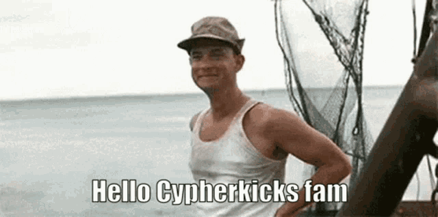 a man wearing a hat and a tank top is standing on a boat near the ocean and says hello cyperkicks fam .
