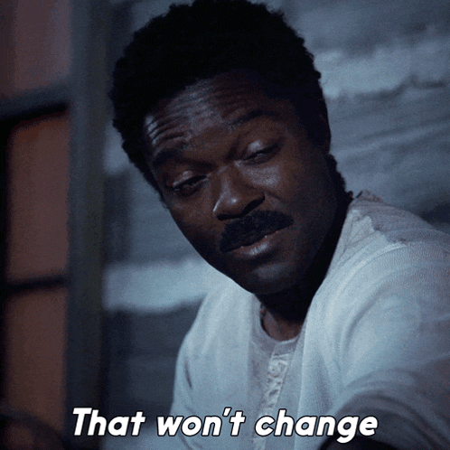 a man with a mustache says that won 't change in white letters