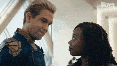 a man and a woman looking at each other with the boys written on the bottom